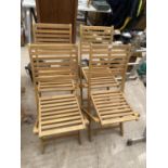 A SET OF FOUR NEW TEAK FOLDING GARDEN CHAIRS