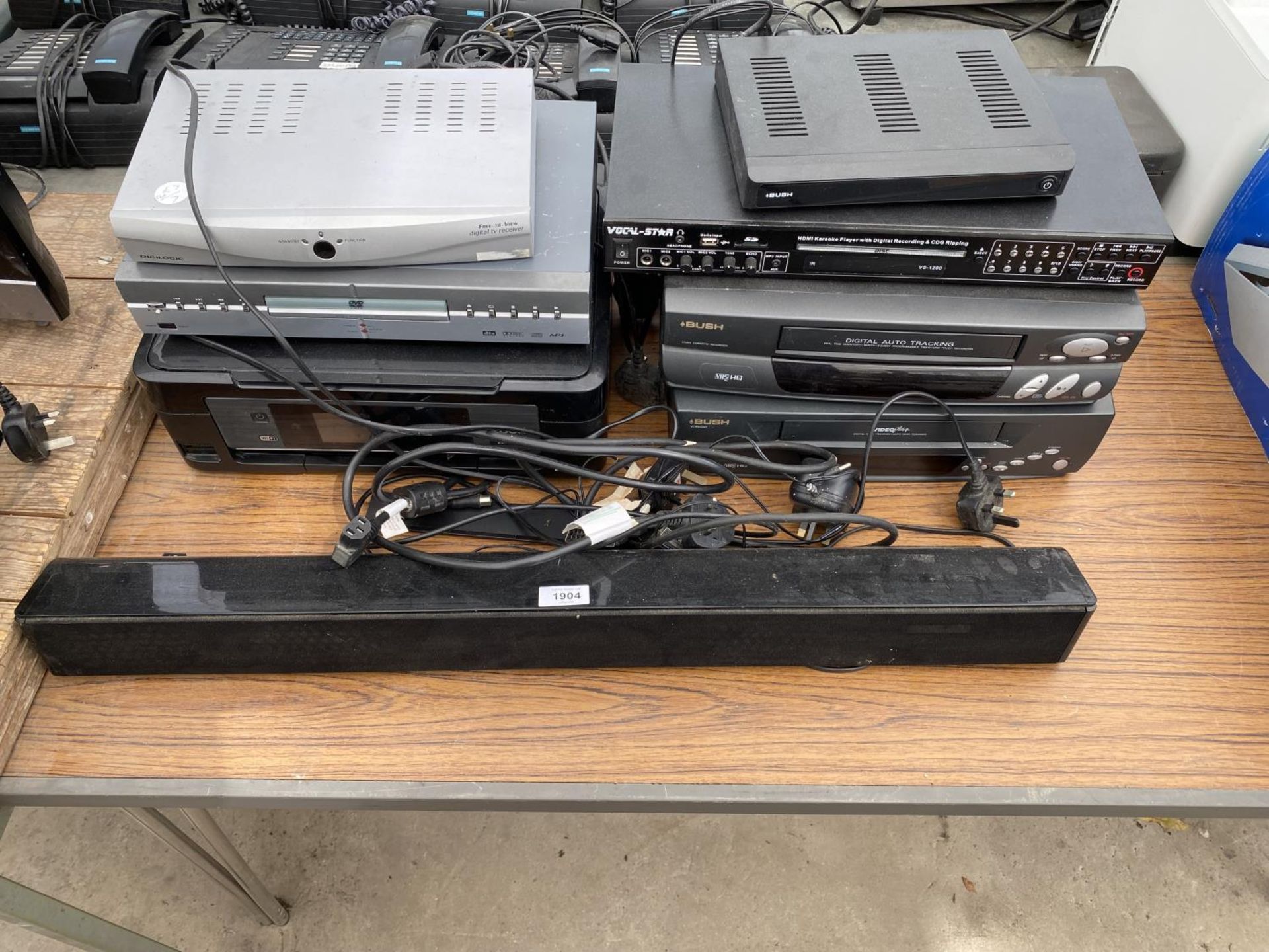 AN ASSORTMENT OF ITEMS TO INCLUDE VHS PLAYERS, A PRINTER AND A SOUND BAR ETC