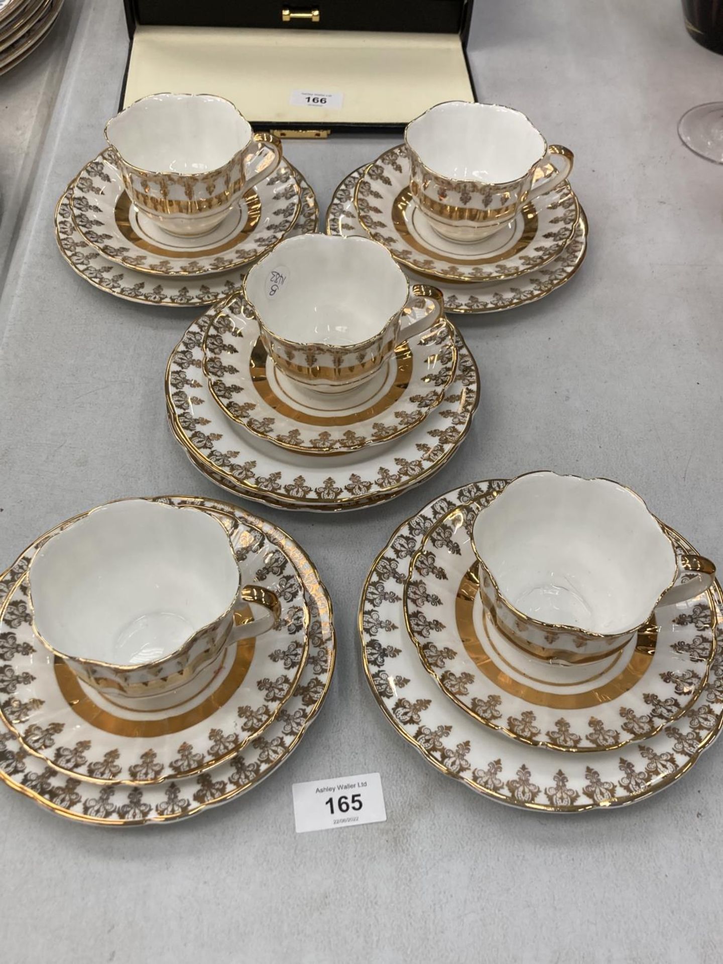 FIVE ROYALTY WHITE AND GOLD COLOURED CHINA TRIOS