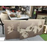 A LARGE THREE PIECE FLORAL CANVAS WALL ART