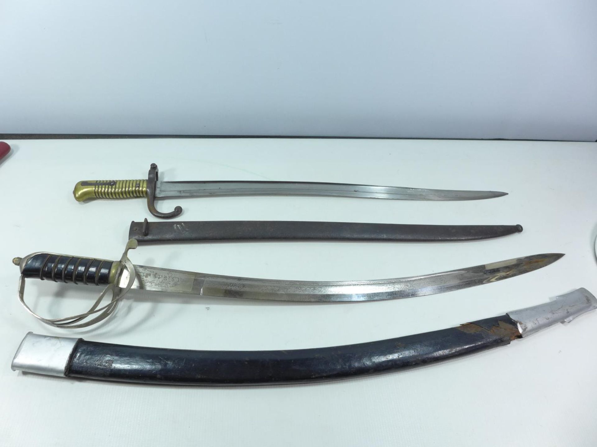 A FRENCH LATE 19TH CENTURY CHASSEPOT BAYONET WITH SCABBARD AND AN INDIAN SWORD WITH SCABBARD