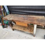 A VINTAGE WORK BENCH WITH A RECORD WOOD VICE