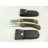 TWO FOLDING KNIVES AND SCABBARDS 10 CM BLADES