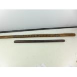 AN AUSTRALIAN ABORIGINE CHIP CARVED CLUB, LENGTH 99CM AND A FURTHER WOODEN CLUB, LENGTH 61CM