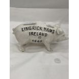 A CAST 'LIMERICK HAMS, IRELAND' BUTCHERS PIG MONEY BOX. HEIGHT 10CM, LENGTH 19CM