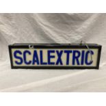 AN ILLUMINATED SCALEXTRIC SIGN 63CM X 17.5CM