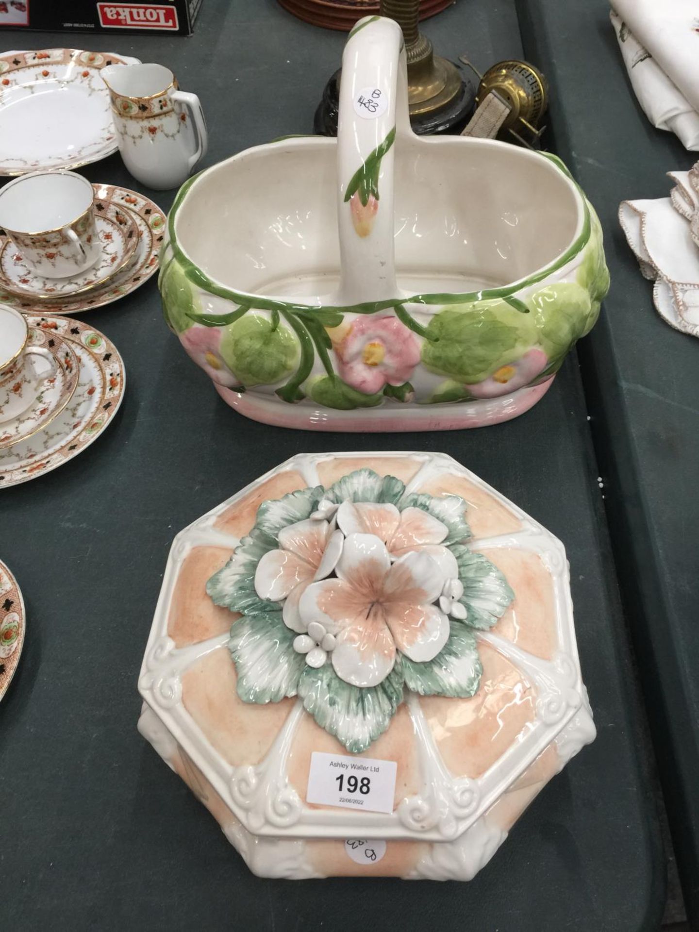 A PLANTER IN THE SHAPE OF A BASKET AND AN APRICOT COLOURED FLORAL TUREEN