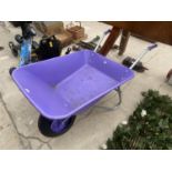 A LARGE PURPLE PLASTIC WHEEL BARROW