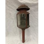 A VINTAGE COACHING LAMP WITH BEVELLED GLASS - MISSING ONE GLASS PANEL HEIGHT APPROX 52CM