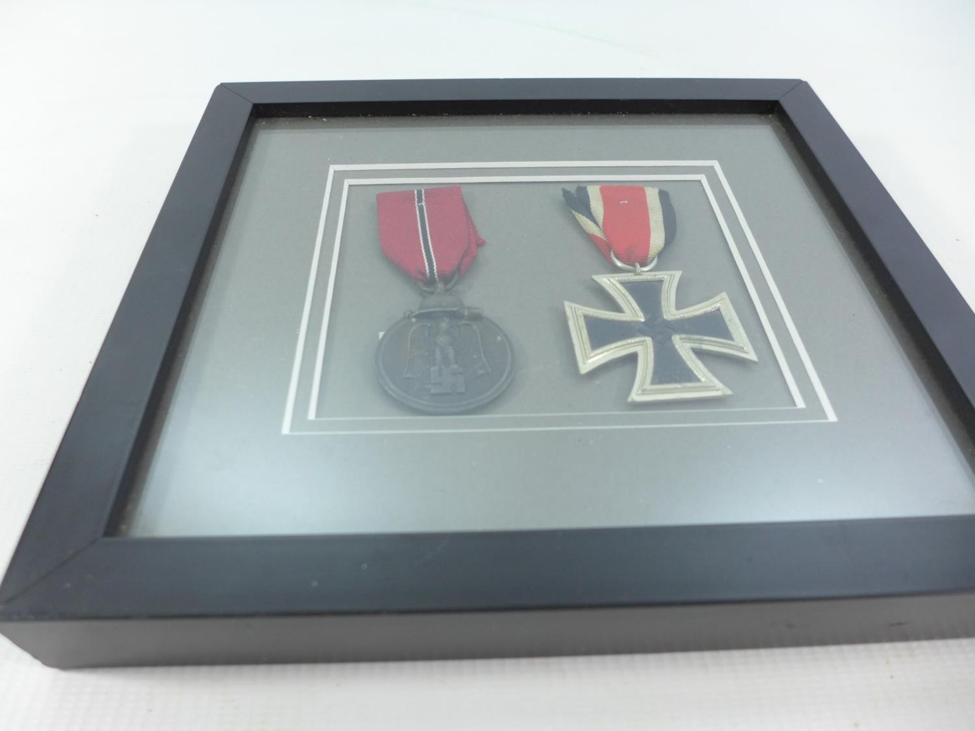 A FRAMED NAZI MEDAL IRON CROSS SECOND CLASS AND A NAZI EASTERN FRONT MEDAL