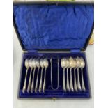 A VINTAGE BOXED SET OF TEASPOONS AND SUGAR TONGS