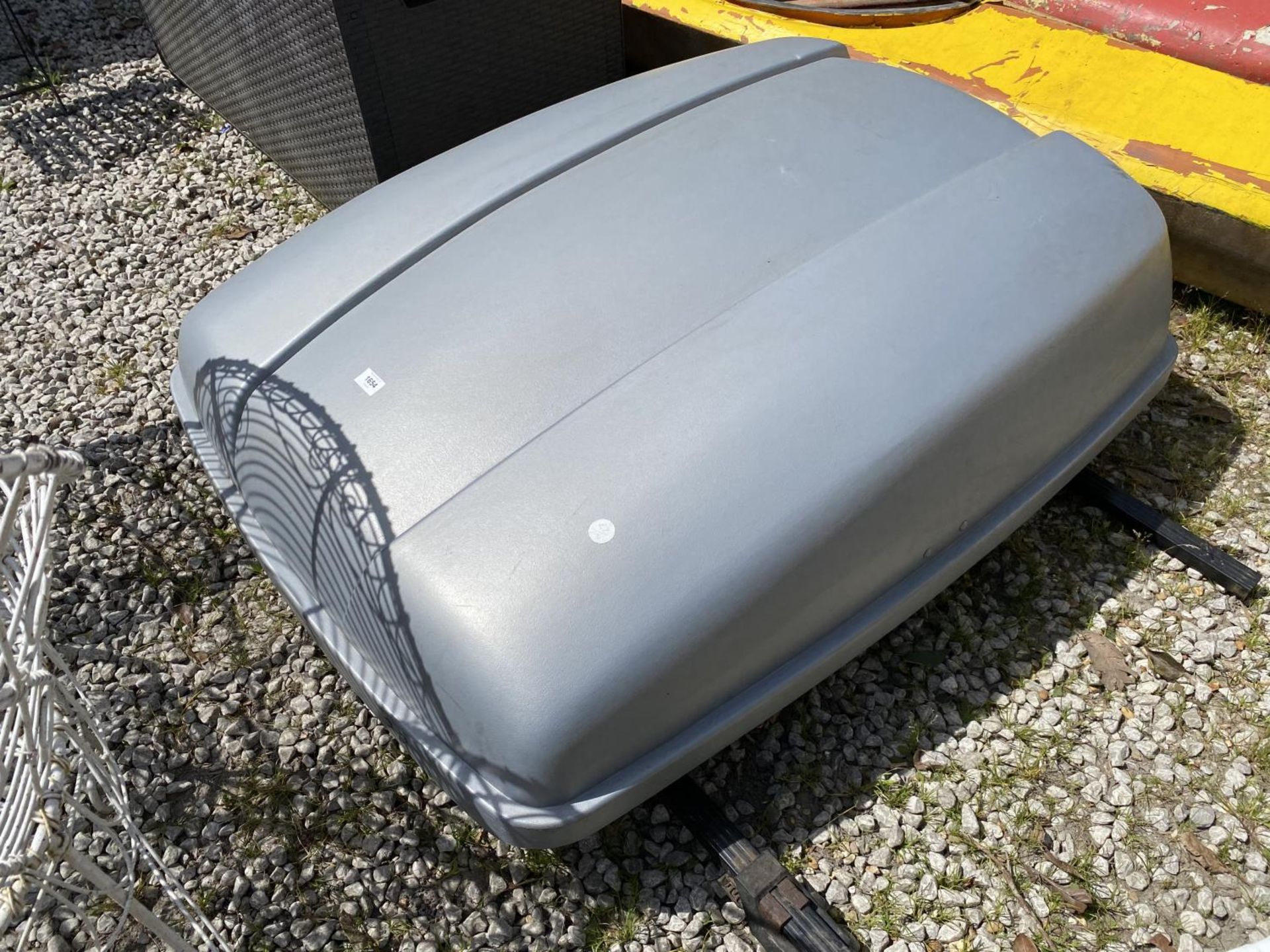 A CAR ROOF BOX WITH ROOF BARS