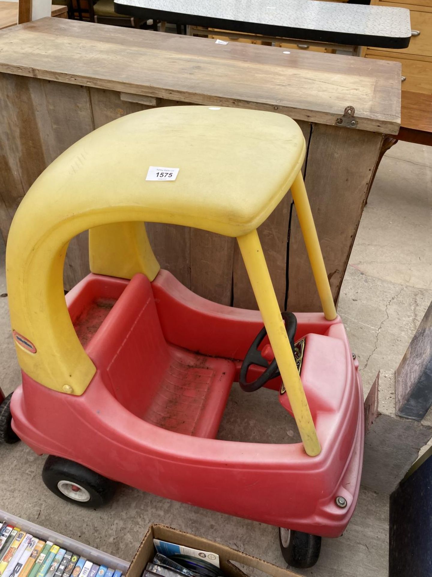 A RED AND YELLOW LITTLE TIKES COZY COUPE CAR