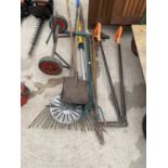 AN ASSORTMENT OF GARDEN TOOLS TO INCLUDE SHEARS, RAKES AND A SHOVEL ETC