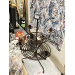 A VINTAGE WROUGHT IRON CIRCULAR CANDLE HOLDER - 53 CM IN HEIGHT