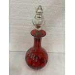 A CRANBERRY AND ENAMEL GLASS DECANTER WITH FLOWER DECORATION HEIGHT 26CM