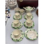 A GREEN AND CREAM ART DECO TEASET TO INCLUDE TEAPOT, CREAM JUG, SUGAR BOWL, CUPS, SAUCERS AND SIDE