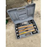 A CASED CLARKE 7 PIECE PANEL BEATING SET