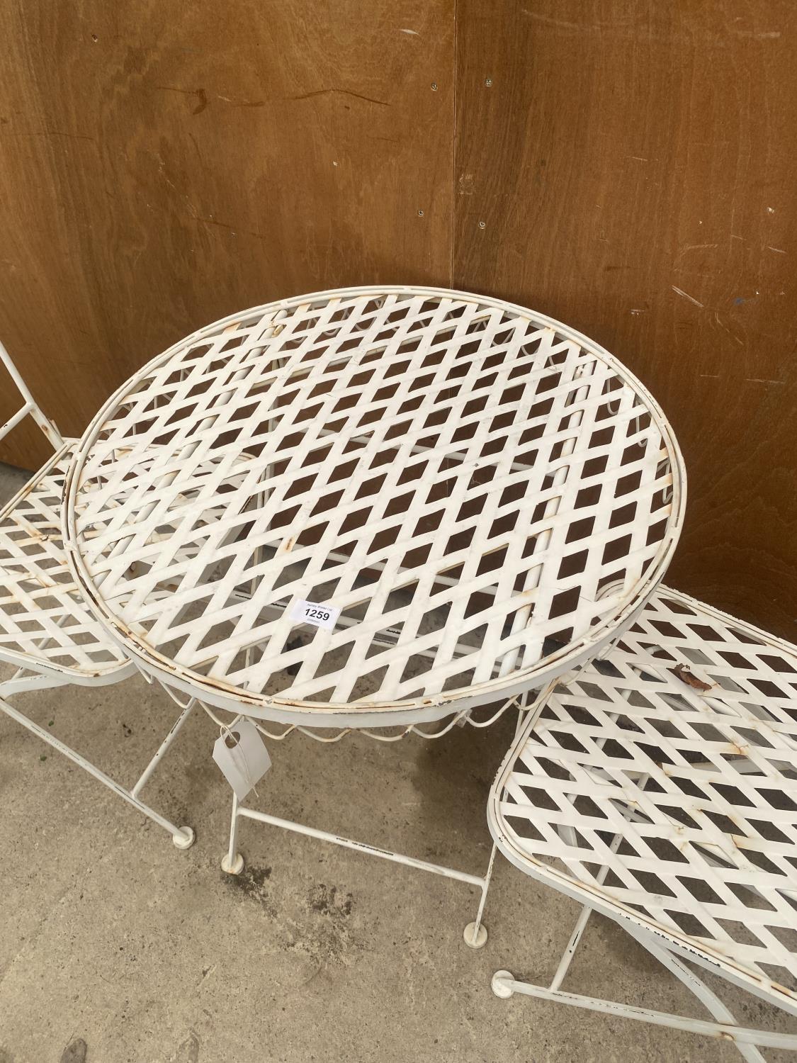 A DECORATIVE WROUGHT IRON BISTRO SET COMPRISING OF A ROUND TABLE AND TWO CHAIRS - Image 2 of 5