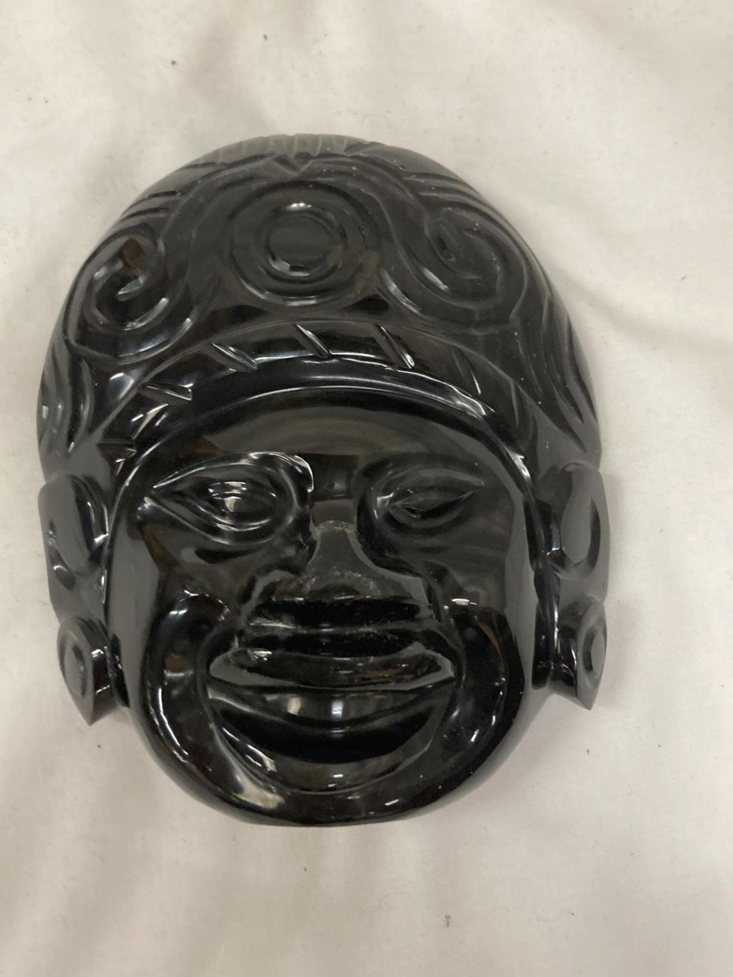 A BLACK STONE MASK 14CM X 12CM