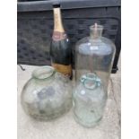 A LARGE MERCIER CHAMPAGNE BOTTLE, A GLASS DEMI JOHN AND TWO FURTHER GLASS VESSELS
