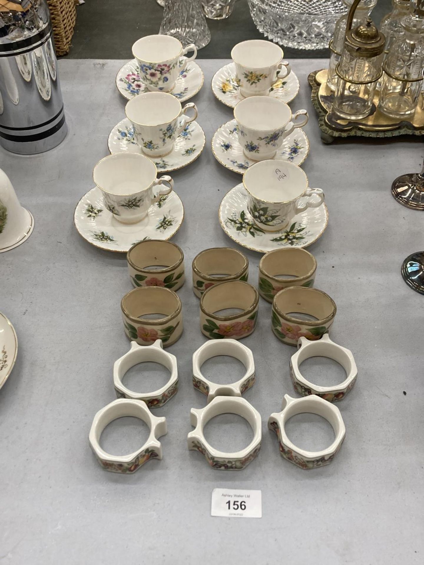 A COLLECTION OF ROYAL WINDOR CUPS AND SAUCERS AND 12 DECORATIVE NAPKIN RINGS