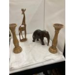 A PAIR OF TREEN CANDLESTICKS HEIGHT 33CM, A CARVED ELEPHANT AND GIRAFFE