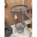 A VINTAGE CAST IRON THREE TIER PLANT STAND WITH LION PAW FEET