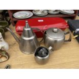 A CAST IRON COOKING POT AND THREE STAINLESS STEEL KITCHEN ITEMS