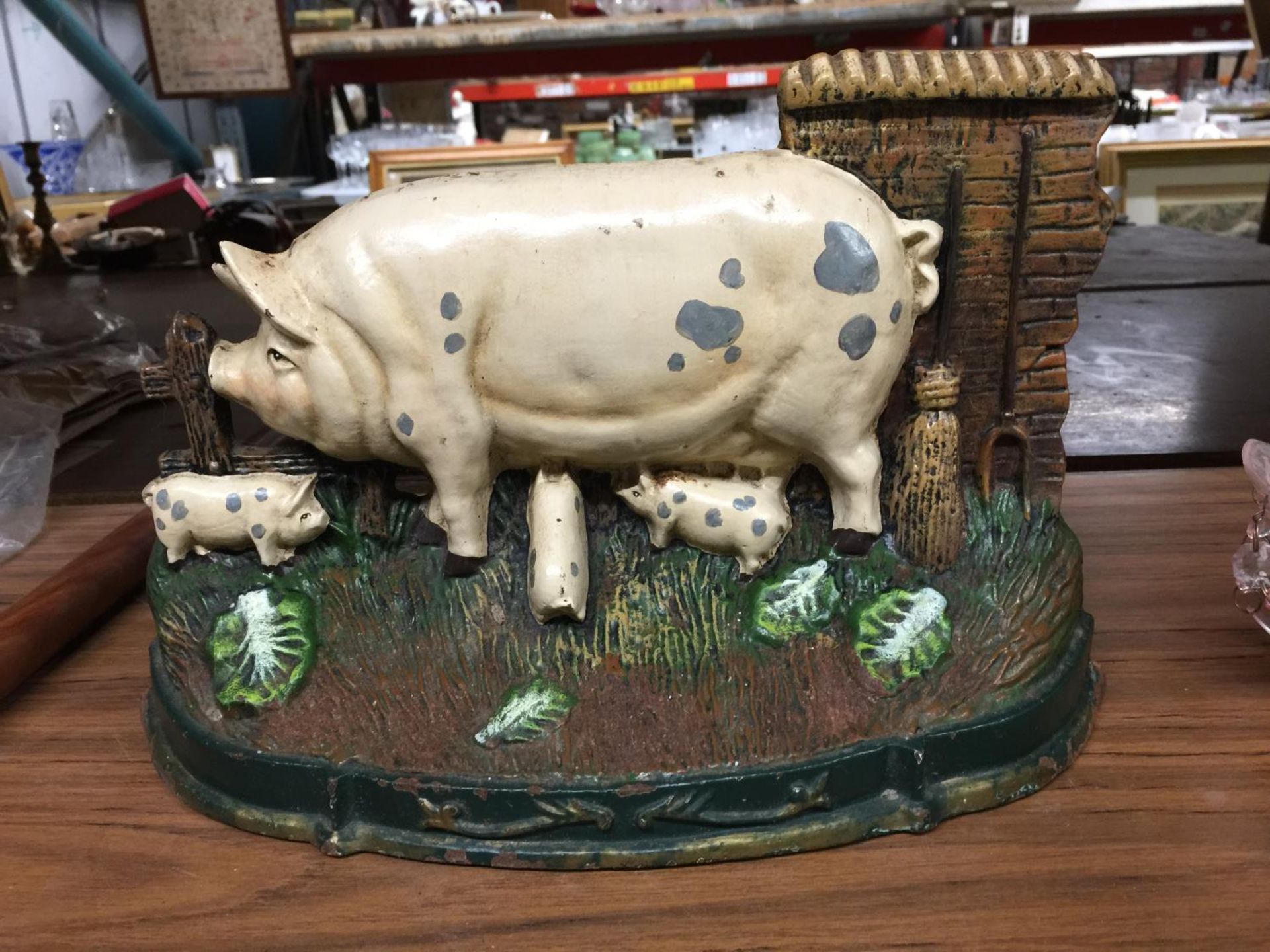 A CAST DOORSTOP OF A PIG HEIGHT 22CM, LENGTH 33CM