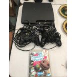 A PLAYSTATION 3 WITH THREE CONTROLLERS AND LITTLE BIG PLANET GAME