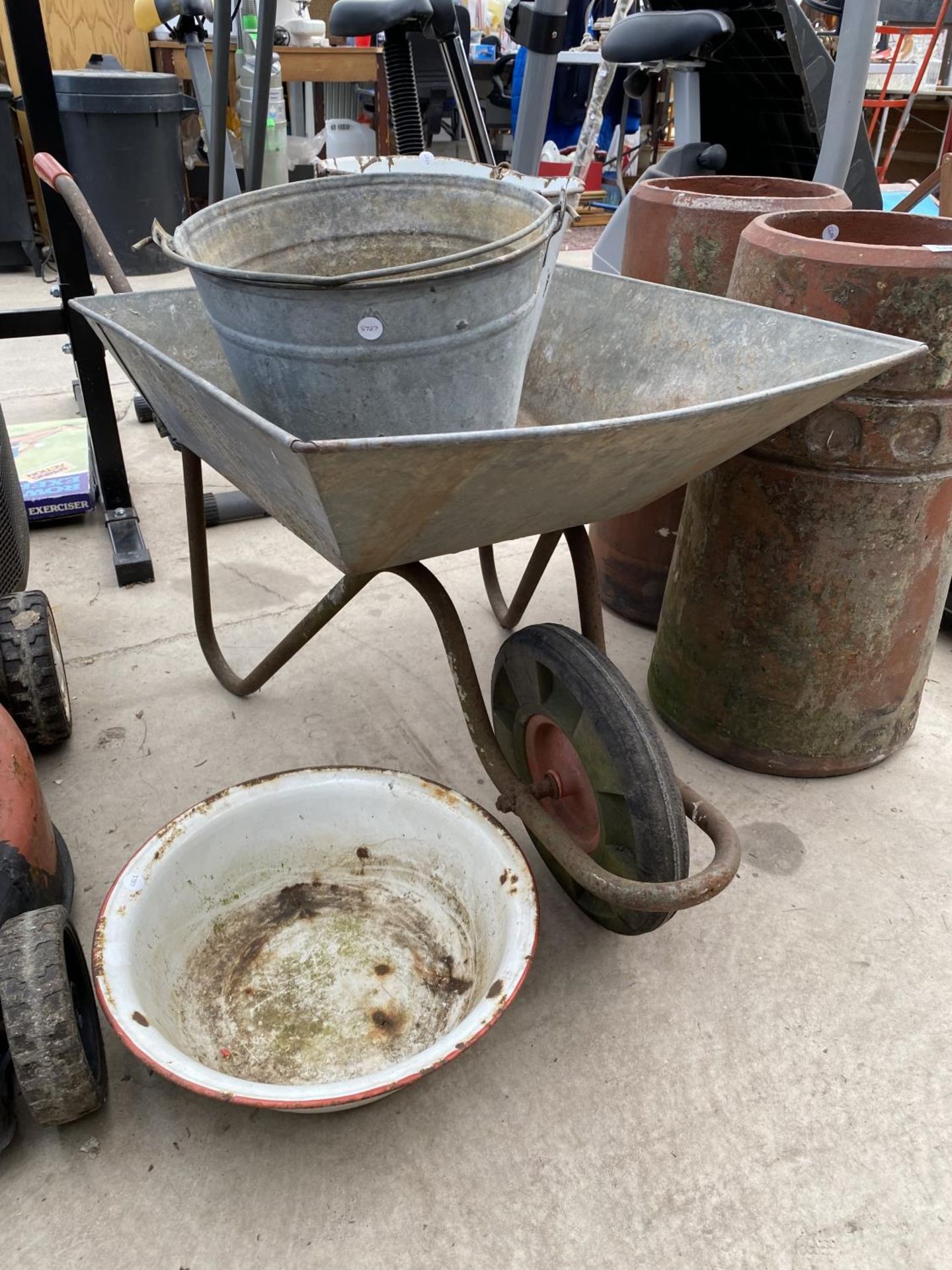 A WHEEL BARROW, A GALVANISED BUCKET AND TWO ENAMEL ITEMS