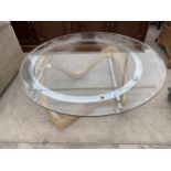 A RETRO GLASS TOP COFFEE TABLE, 35" DIAMETER, ON FIVE SHAPED AND CONTORTED WOODEN BASE