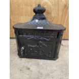 A SMALL CAST IRON LETTER BOX WITH KEY