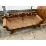 A MINIATURE HARDWOOD SCROLL END COUCH WITH SPLIT-CANE SEAT AND BACK, 42" WIDE