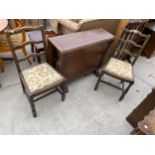 A MID 20TH CENTURY OAK DROP-LEAF DINING TABLE AND TWO CHAIRS