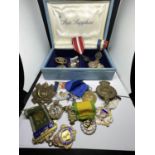 A BOX CONTAINING A LARGE QUANTITY OF MEDALS
