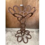 A DECORATIVE PLANTER FORMED FROM HORSE SHOES