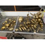 A LARGE ASSORTMENT OF BRASS ITEMS TO INCLUDE BUD VASES, CHESTNUT ROASTERS AND VARIOUS ANIMAL FIGURES