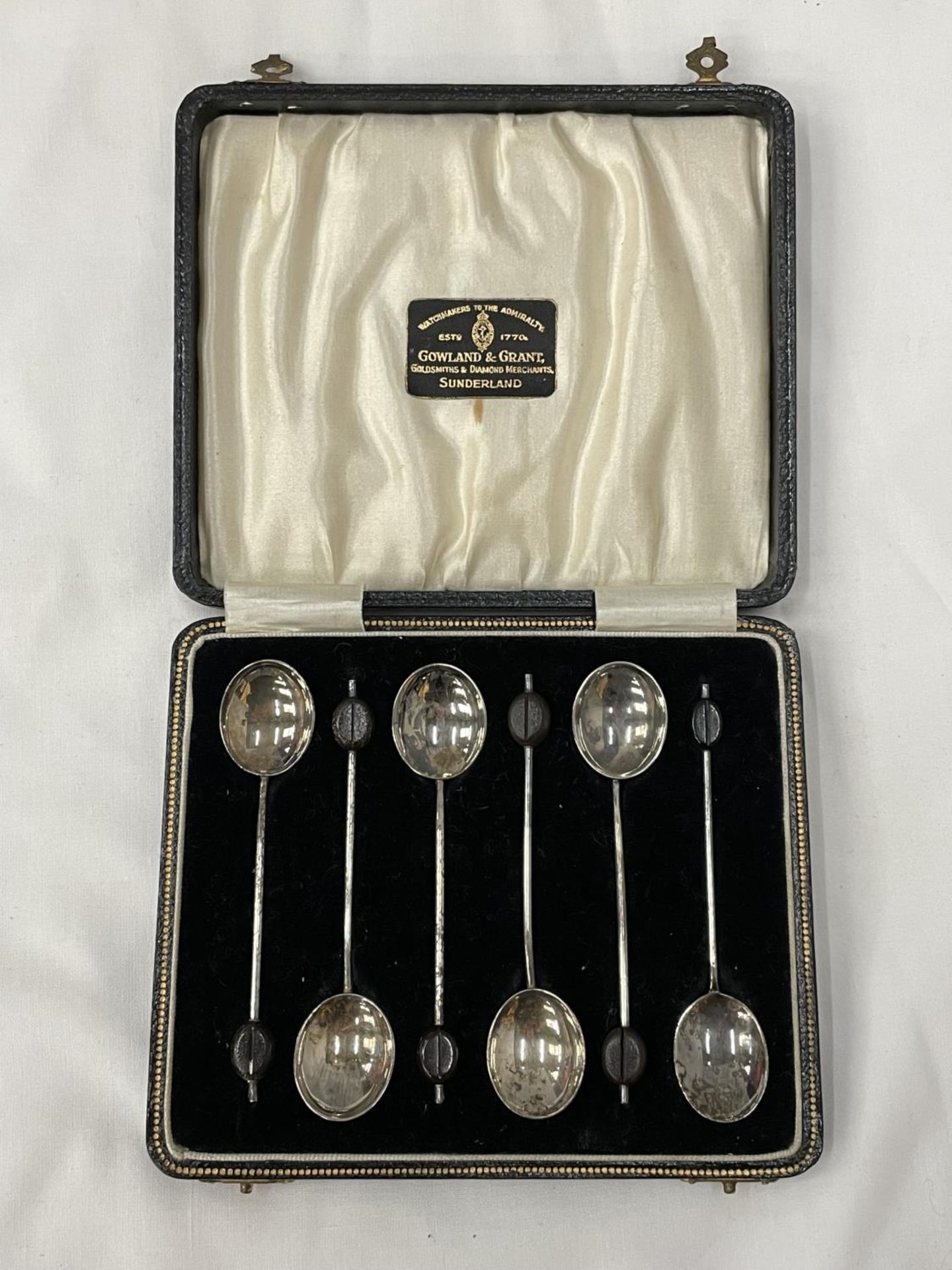 A BOXED SET OF SIX HALLMARKED BIRMINGHAM COFFEE BEAN SPOONS