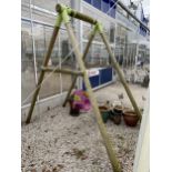 A WOODEN FRAMED CHILDRENS SWING WITH METAL BRACKETS