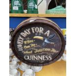 A WOODEN BARREL TOP 'LOVELY DAY FOR A GUINNESS' SIGN DIAMETER 38CM