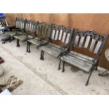 A SET OF FIVE HEAVY WOODEN SLATTED AND CAST IRON GARDEN SEATS