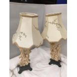 A PAIR OF CARVED ORIENTAL STYLE TABLE LAMPS DEPICTING LADIES AND FLOWERS