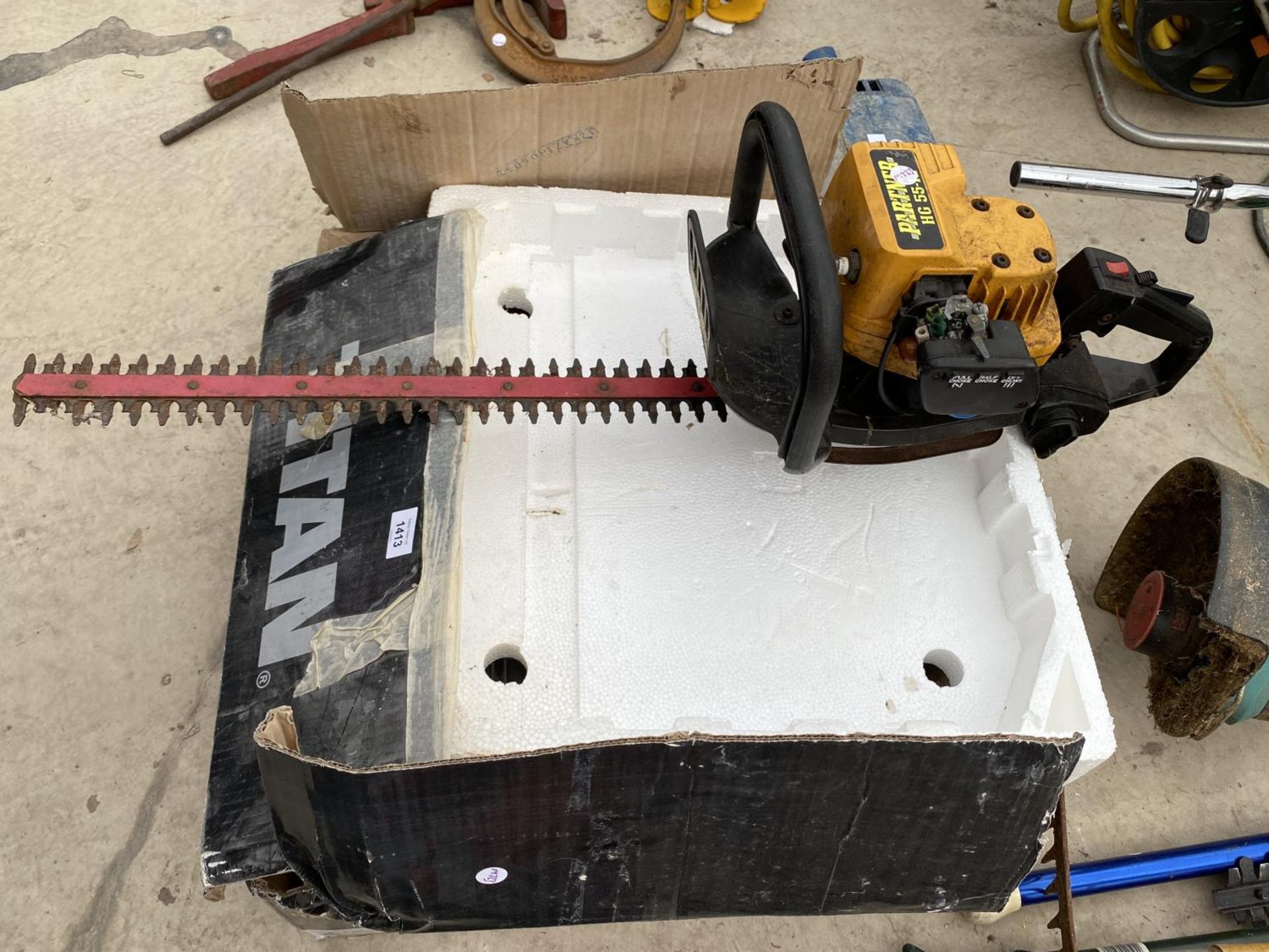 A PETROL ENGINE HEDGE TRIMMER AND A TITAN TTB336TCB TILE CUTTER