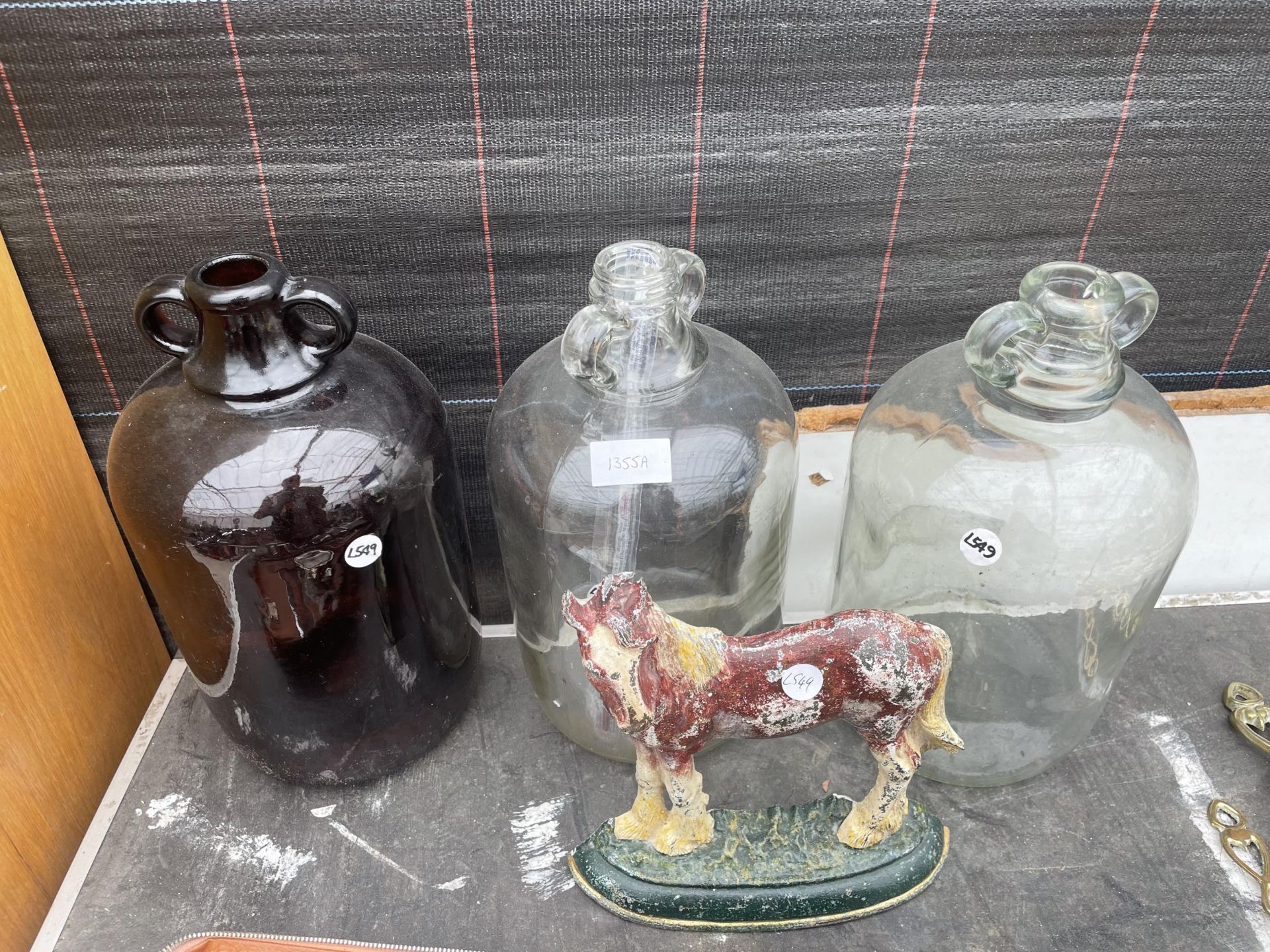 THREE GLASS DEMI JOHNS AND A CAST HORSE DOOR STOP