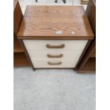 A MODERN THREE DRAWER BEDSIDE CHEST