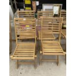 A SET OF FOUR NEW TEAK FOLDING GARDEN CHAIRS