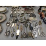 A LARGE QUANTITY OF FLATWARE TO INCLUDE SERVING SPOONS, CAKE SLICES, KNIVES, FORKS, SPOONS,