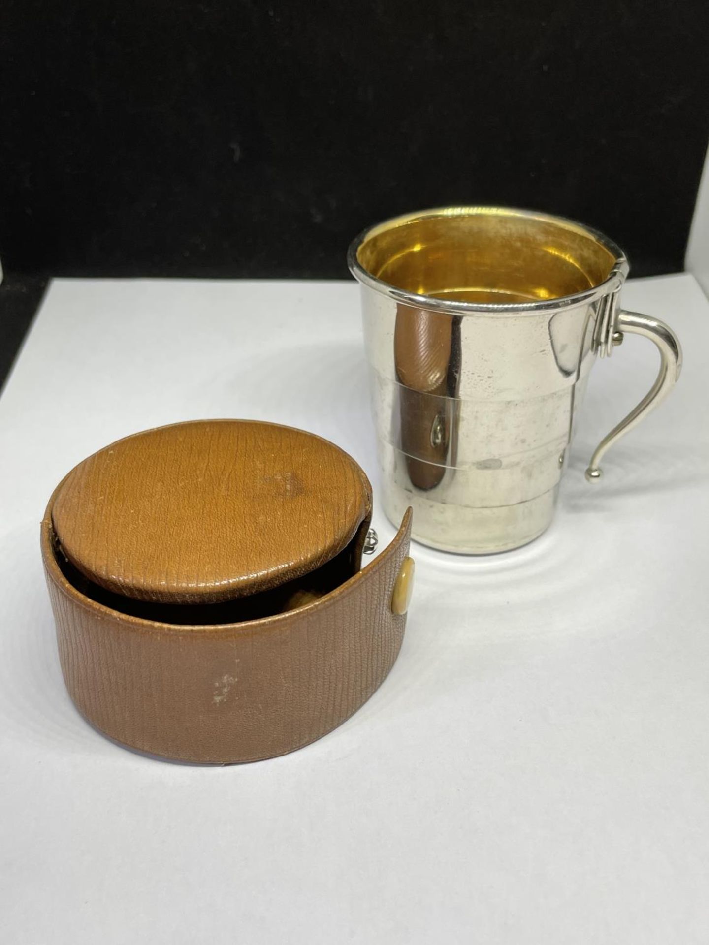 A CASED TRAVEL CUP WITH HANDLE